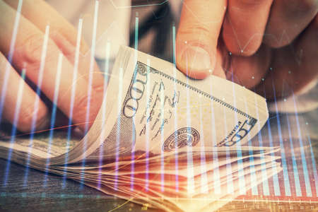 Multi exposure of forex graph drawing hologram and USA dollars bills and man hands. Technical Analysis concept.の写真素材