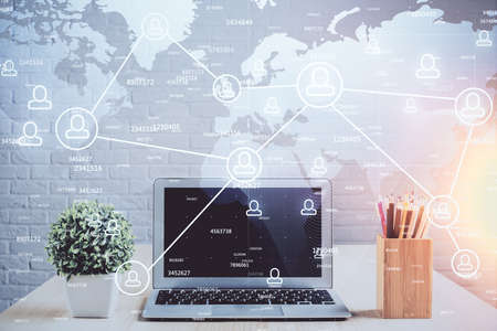 Computer on desktop with social network hologram. Double exposure. Concept of international people...