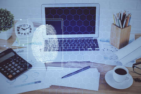Computer on desktop in office with finger print drawing. Double exposure. Concept of business data...