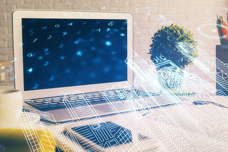 Desktop computer background in office and big town buildings hologram drawing. Double exposure. Smart city concept.の写真素材