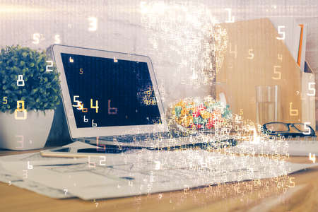Computer on desktop in office with technology theme hologram. Double exposure. Tech concept.