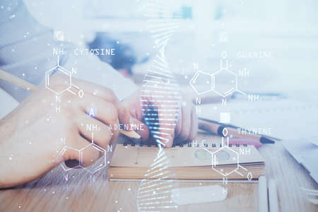 Man's hands working with notes background. Genetic engineering and gene manipulation concept. Double...