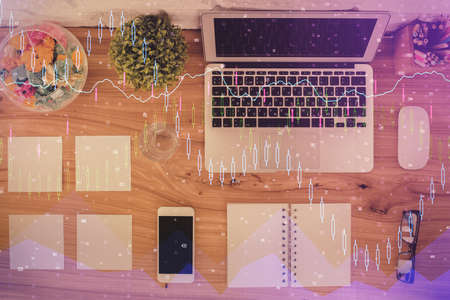 Stock market graph and top view computer on the table background. Multi exposure. Concept of financial education.の写真素材