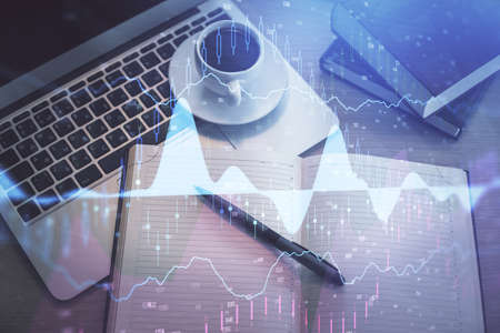 Stock market graph and top view computer on the table background. Multi exposure. Concept of...