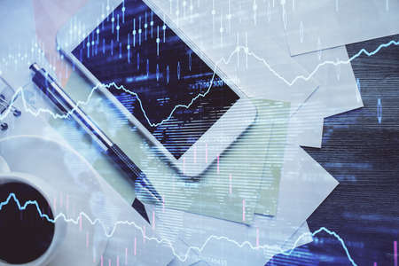 Multi exposure of forex graph hologram over desktop with phone. Top view. Mobile trade platform...