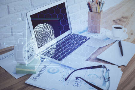 Computer on desktop in office with finger print drawing. Double exposure. Concept of business data...