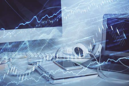 Financial market graph hologram and personal computer on background. Multi exposure. Concept of...