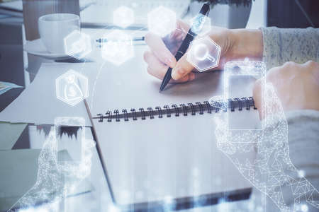 Technology theme hologram over woman's hands taking notes background. Concept of Tech. Double exposureの写真素材