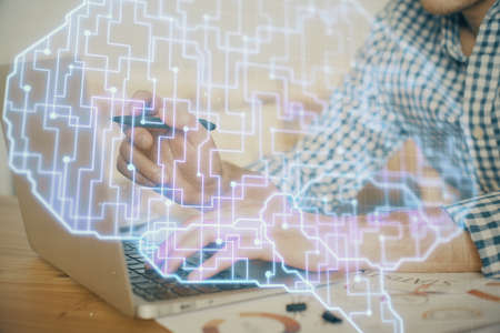 Man typing on keyboard background with brain hologram. Concept of big Data.の写真素材