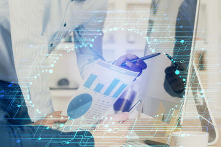 Double exposure of technology hologram with man working on computer background. Concept of big data.