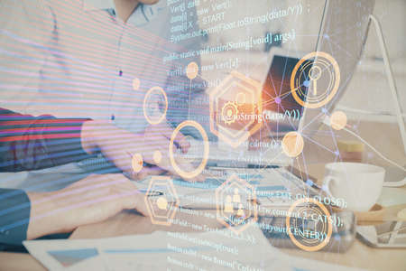 Double exposure of technology hologram with man working on computer background. Concept of big data.