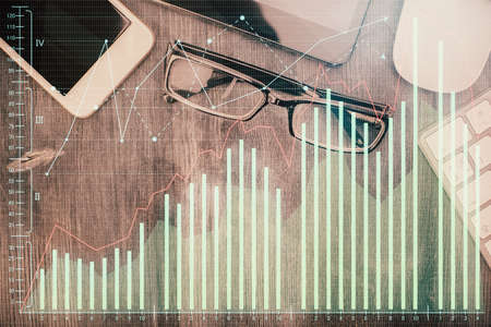 Multi exposure of forex graph hologram over desktop with phone. Top view. Mobile trade platform...