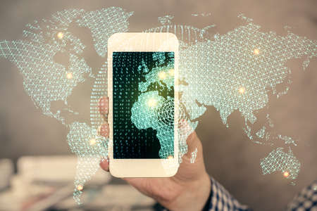Double exposure of man's hands holding and using a phone and international business theme drawing.の写真素材