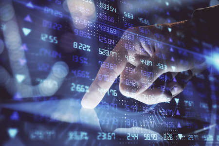 Multi exposure of man's hands holding and using a phone and financial chart drawing. Market analysis...