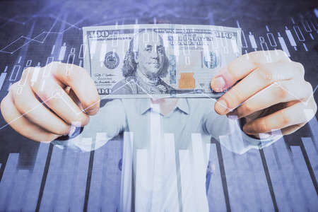 Multi exposure of financial graph drawing hologram and USA dollars bills and man hands. Analysis...