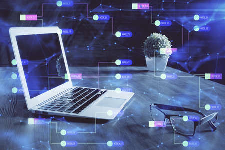 Double exposure of laptop computer and technology theme hologram. Concept of freelance work.
