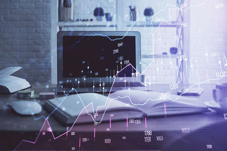 Forex market graph hologram and personal computer on background. Double exposure. Concept of...