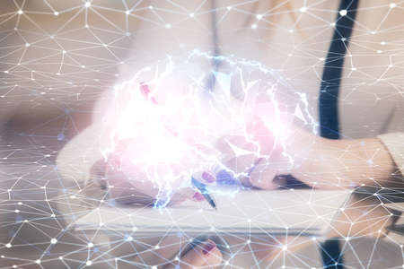 Multi exposure of woman's writing hand on background with brain hud. Concept of learning.の写真素材