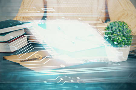Double exposure of writing hands on background with data solution hologram on front. Technology...