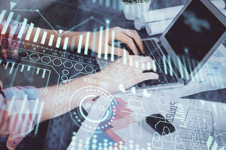 Technology theme hologram with man working on computer on background. High tech concept. Multi...