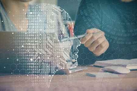 Businessman with computer background with brain theme hologram. Concept of brainstorm. Multi...