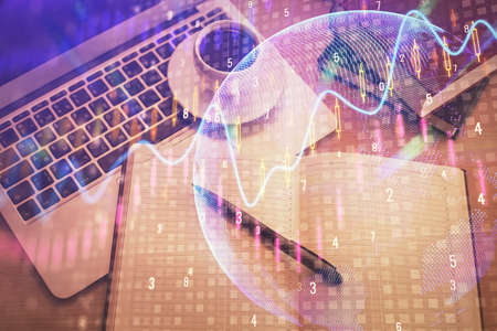 Stock market graph and top view computer on the table background. Multi exposure. Concept of...
