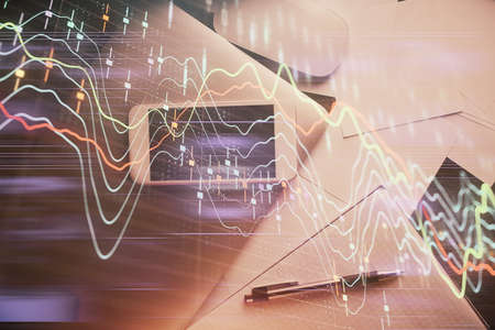 Multi exposure of forex graph hologram over desktop with phone. Top view. Mobile trade platform...