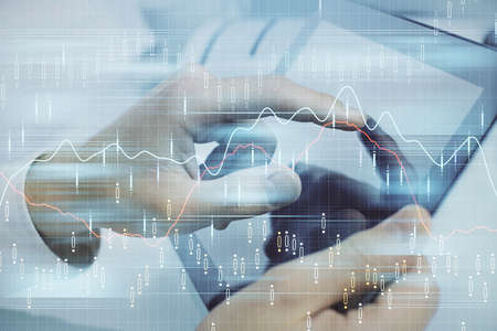 Multi exposure of man's hands holding and using a phone and financial chart drawing. Market analysis...