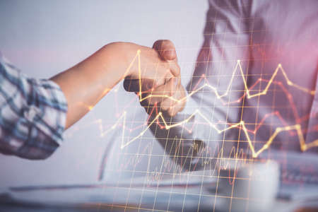 Double exposure of forex graph hologram and handshake of two men. Stock market concept.
