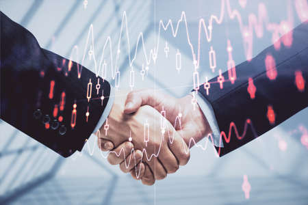 Double exposure of forex graph hologram and handshake of two men. Stock market concept.