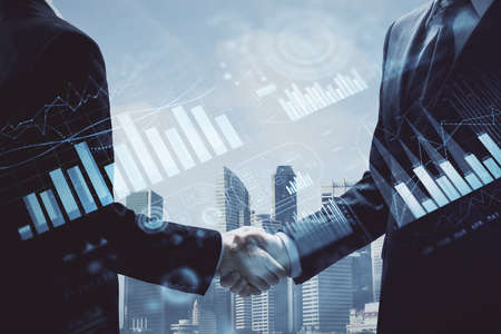 Double exposure of forex graph hologram and handshake of two men. Stock market concept.の写真素材