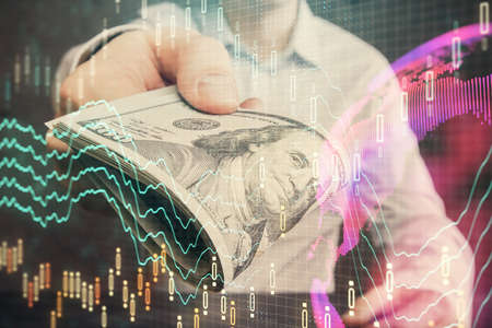 Multi exposure of financial graph drawing hologram and USA dollars bills and man hands. Analysis concept.の写真素材