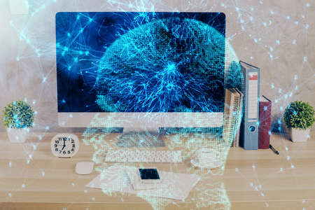 Double exposure of desktop with computer and brain drawing hologram. Artificial intelligence concept.の写真素材