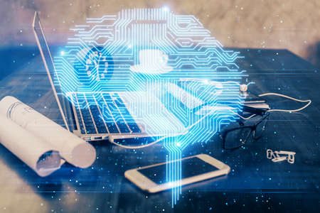 Double exposure of desktop with computer and brain drawing hologram. Artificial intelligence...