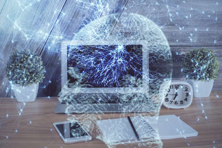 Multi exposure of work table with computer and brain hologram. Brainstorm concept.