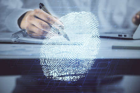 Blue fingerprint hologram over woman's hands taking notes background. Concept of protection. Double exposureの写真素材