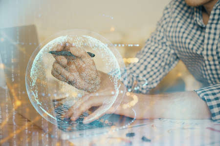 Multi exposure of world map hologram with man working on computer on background. Concept of...