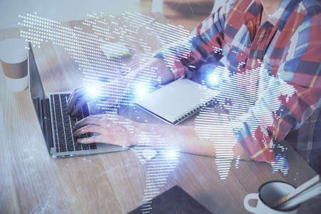 Social network theme hologram with businessman working on computer on background. Concept of world...