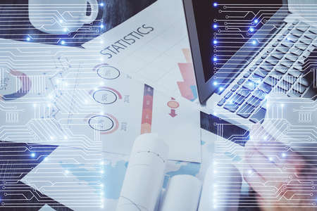 Technology theme hologram with man working on computer on background. High tech concept. Multi...