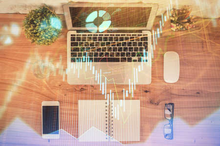 Multi exposure of financial chart drawing over table background with computer. Concept of research. Top view.の写真素材