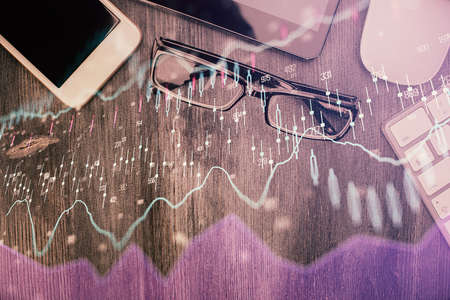 Multi exposure of forex graph hologram over desktop with phone. Top view. Mobile trade platform concept.の写真素材