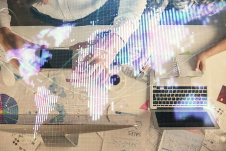 Double exposure of man and woman working together and business theme hologram drawing. Computer...