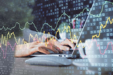 Double exposure of woman hands typing on computer and forex chart hologram drawing. Stock market...