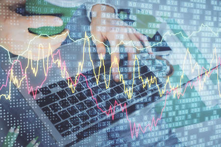 Double exposure of woman hands typing on computer and forex chart hologram drawing. Stock market...