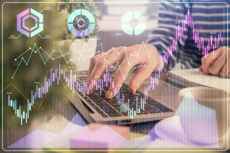 Double exposure of woman hands typing on computer and forex chart hologram drawing. Stock market...
