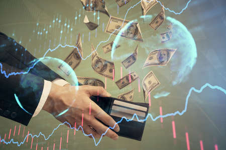 Multi exposure of financial graph drawing hologram and USA dollars bills and man hands. Analysis...
