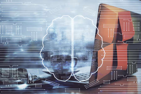 Multi exposure of work space with computer and human brain hologram. Brainstorm concept.