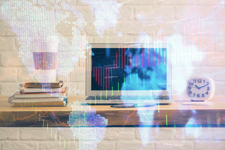 Financial chart drawing and table with computer on background. Double exposure. Concept of international markets.の写真素材