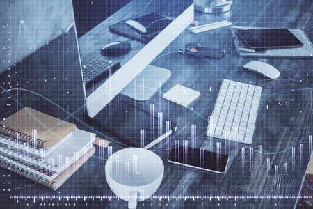Double exposure of graph and financial info and work space with computer background. Concept of...