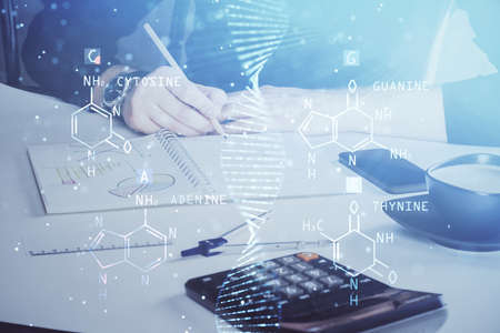 Man's hands working with notes background. Genetic engineering and gene manipulation concept. Double...
